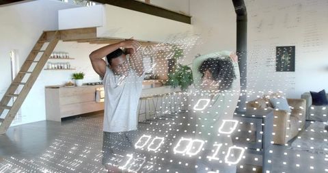 Sunlit couple stretching in modern loft with augmented reality binary overlay