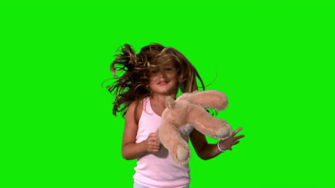 Joyful Child Jumping with Teddy on Green Screen Background