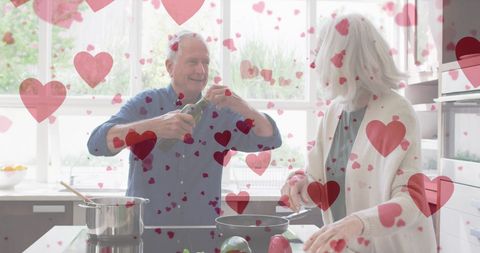 Senior Couple in Kitchen Surrounded by Hearts