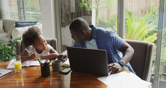 Father Helping Daughter with Homework at Dining Table - Download Free Stock Images Pikwizard.com