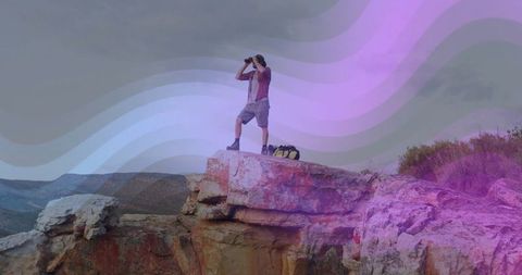 Explorer on Sandstone Cliff Scanning Horizons with Binoculars