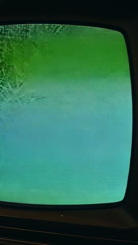 Vertical video of vintage CRT television displaying green-blue glitch bands and scanlines
