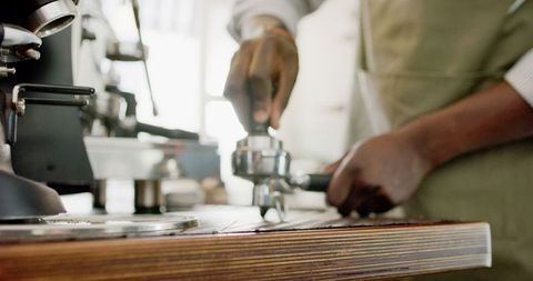 Barista perfecting espresso shot in artisan coffee house