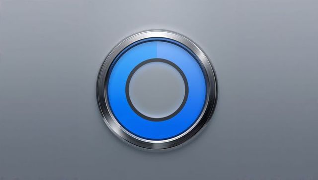 Glowing blue circular control button with chrome bezel on matte gray panel, high-tech interface elem