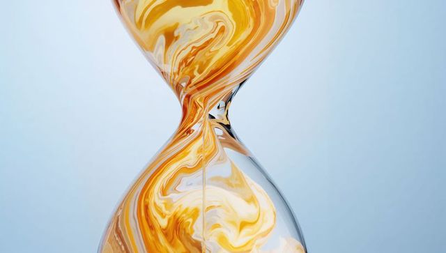 Elegant glass hourglass featuring golden swirling liquid