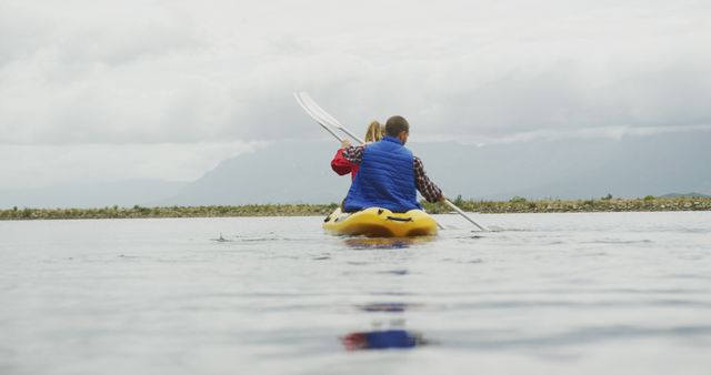 Couple Kayaking on Calm Lake Surrounded by Mountains - Download Free Stock Images Pikwizard.com