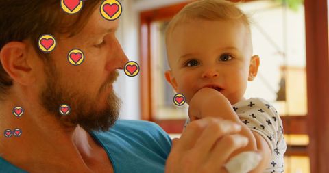 Father Bonding with Baby Surrounded by Heart Icons