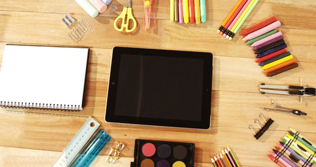 Top View of Office and Art Supplies with a Tablet on Wooden Desk - Download Free Stock Images Pikwizard.com