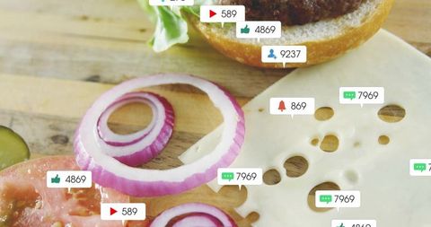 Preparing burger toppings on wooden board with social media engagement icons