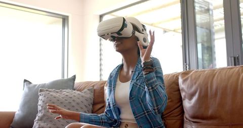 Young Woman Experiencing VR Technology in Living Room