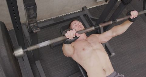 Athletic Man Powerlifting Barbell in Modern Gym Session