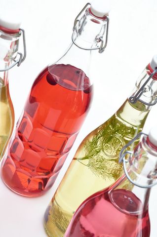 Assorted decorative bottles of colorful homemade beverages