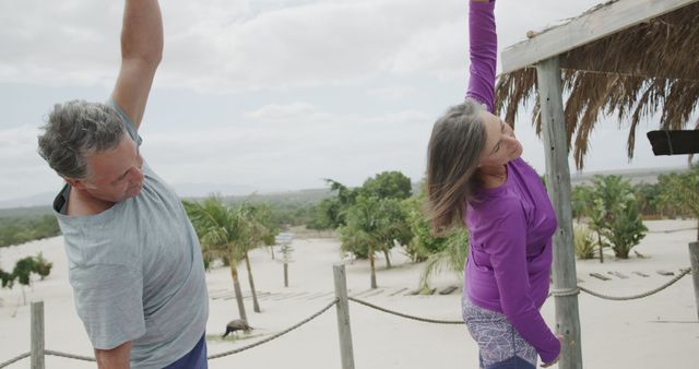 Senior Couple Stretching Outdoor on Wooden Deck in Tropical Setting - Download Free Stock Images Pikwizard.com