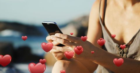 Woman Texting on Beach with Digital Hearts Overlay - Download Free Stock Images Pikwizard.com