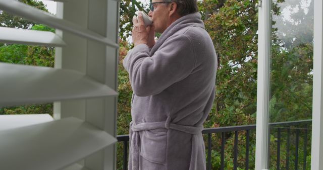 Man Drinking Coffee on Balcony in Morning - Download Free Stock Images Pikwizard.com