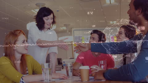 Colleagues Shaking Hands in Modern Office with Data Overlay