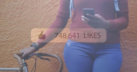 Social media influence: woman engaged on smartphone with bike