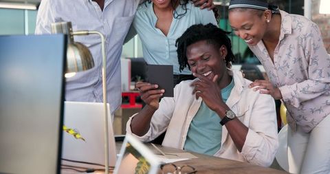 Diverse Team Celebrating Success with Excited Colleague in Office