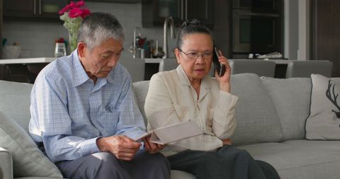 Senior Asian Couple Using Phone and Tablet in Living Room - Download Free Stock Images Pikwizard.com