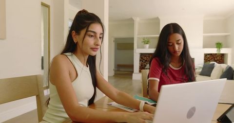 Diverse friends working together at cozy home workspace