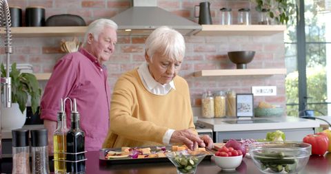 Senior Couple Joyfully Preparing Meal in Modern Kitchen - Download Free Stock Images Pikwizard.com
