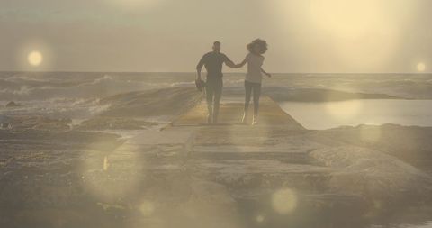 Romantic African American Couple Running on Seaside Rocks