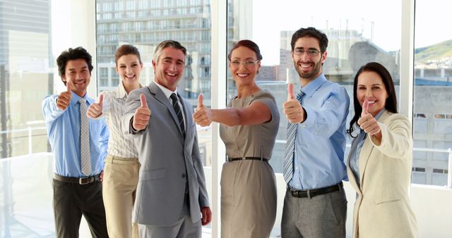 Diverse Business Team Giving Thumbs Up in Bright Office Setting - Download Free Stock Images Pikwizard.com