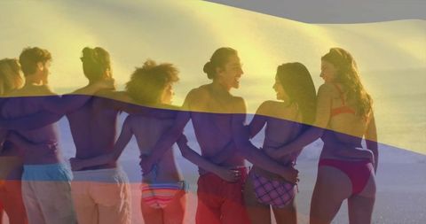 Friends Enjoying Sunset at Beach in Swimwear