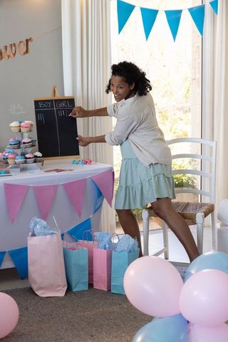 Expectant mother enjoying gender reveal party celebration