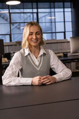 Businesswoman Sitting at Desk in Modern Industrial Office
