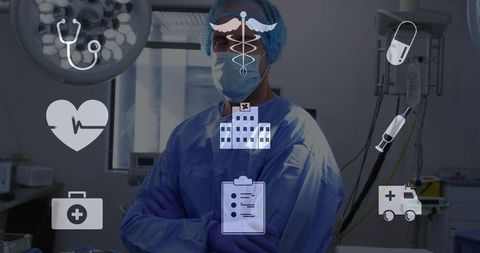 Surgeon standing in sterile operating room wearing surgical gown, cap, mask and gloves