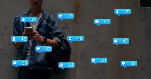 Young man scrolling smartphone surrounded by floating social media notification bubbles