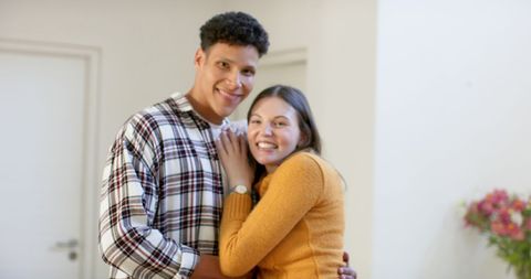 Diverse Couple Smiling Embracing in Cozy Interior - Download Free Stock Images Pikwizard.com