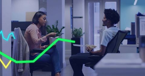 Colleagues exchanging cash and documents during casual office break in open-plan workspace