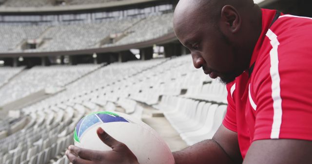 Thoughtful Rugby Player Holding Ball in Stadium - Download Free Stock Images Pikwizard.com