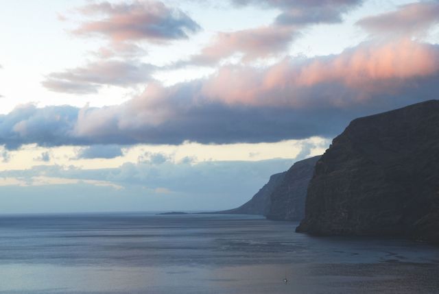 Dramatic Coastal Cliff with Pink Cloudscape During Sunset - Download Free Stock Photos Pikwizard.com