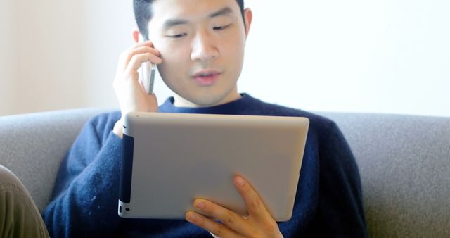 Man Multitasking with Smartphone and Tablet in Modern Setting - Download Free Stock Images Pikwizard.com