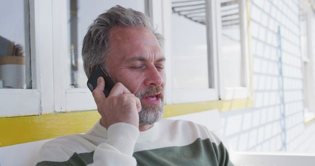 Middle-aged man with beard making call on smartphone outdoors - Download Free Stock Images Pikwizard.com