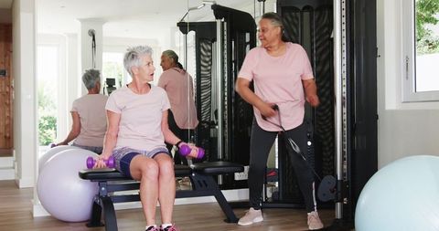 Active Senior Lesbian Couple Exercising at Home Gym for Fitness