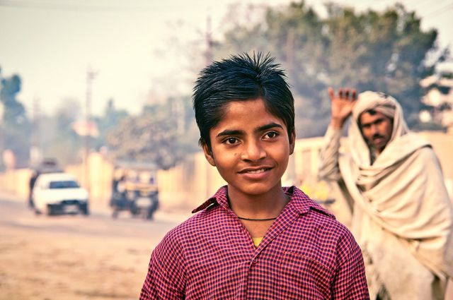 Smiling Indian Boy in Vintage Checkered Shirt Outdoors - Download Free Stock Photos Pikwizard.com