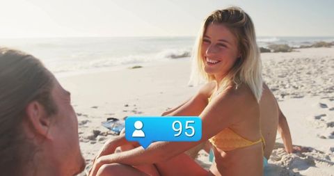 Smiling Woman in Bikini Relaxing on Sunny Beach with Friend