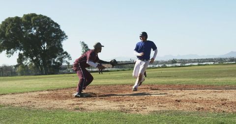Competitive Baseball Players Racing to Home Plate in Dynamic Action