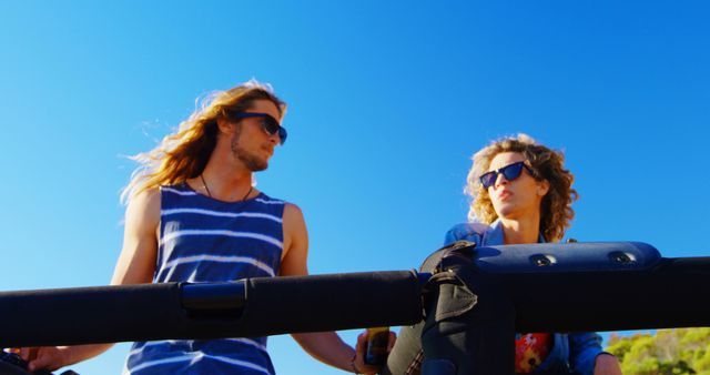 Young Couple Enjoying a Road Trip Under Clear Blue Sky - Download Free Stock Images Pikwizard.com