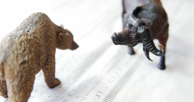 Scene shows bull and bear figures placed on financial papers, symbolizing stock market trends. Useful for blogs, articles, and presentations about financial markets, investment strategies, or economic analysis. Can be used to illustrate market volatility and investment trends.