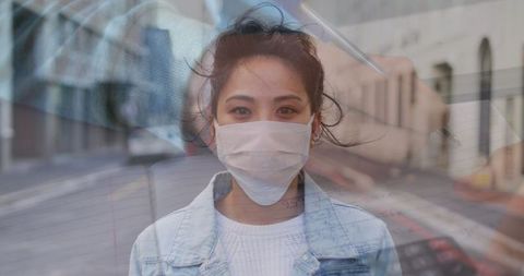 Urban woman wearing protective mask in city atmosphere