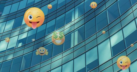 Floating Emojis Over Modern Glass Building Concept