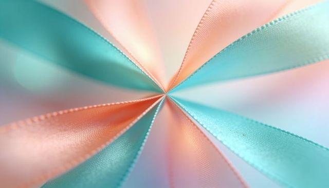 Pastel peach and turquoise satin ribbons converging in radial symmetry macro, soft bokeh