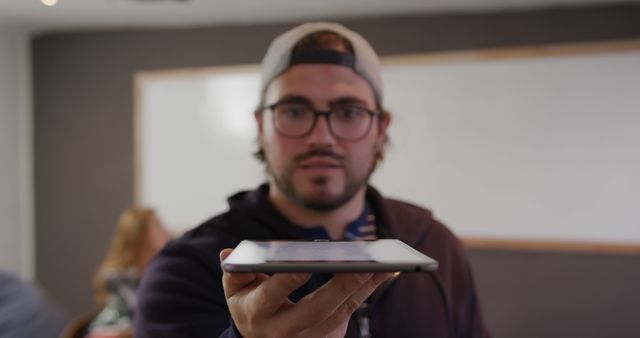 Young Man Holding Tablet in Classroom - Download Free Stock Images Pikwizard.com