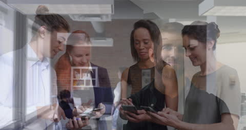 Diverse Business Team Using Smartphones in Modern Office