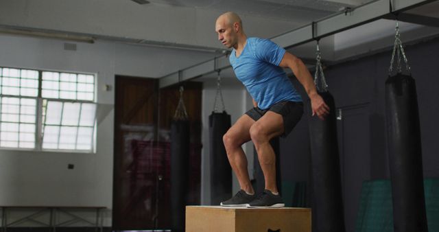 Man Exercising with Box Jumps in Gym - Download Free Stock Images Pikwizard.com